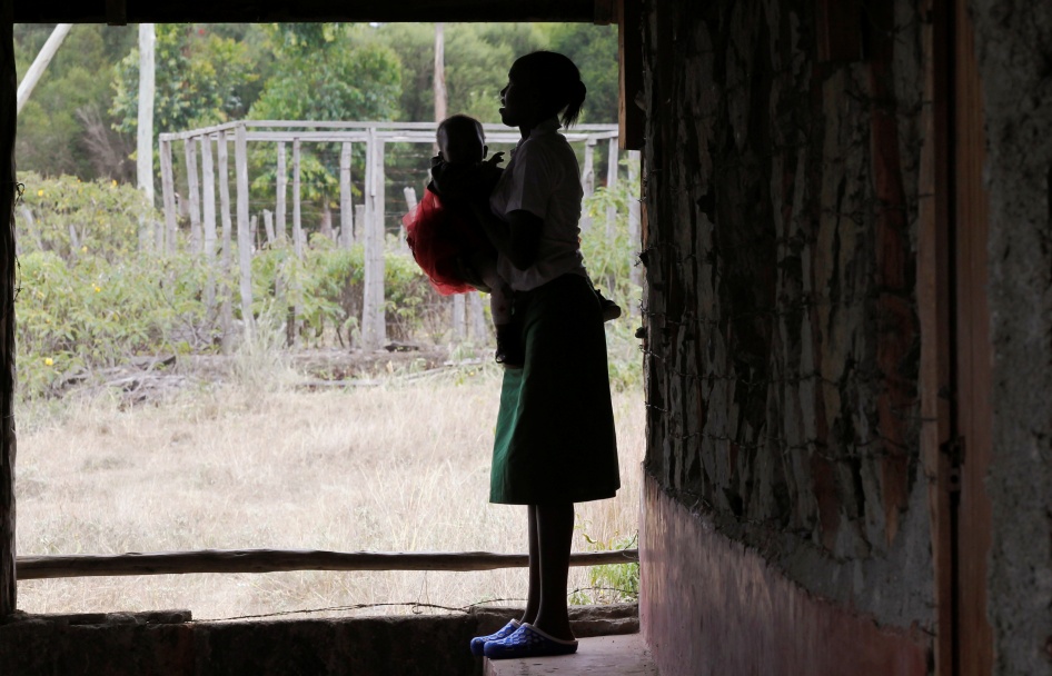 A 19-year-old woman carries her child outside her secondary school classroom in Nyeri, Kenya, January 8, 2021.