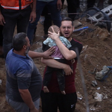 In the rubble of the Engineers’ Building, Karam al-Sharif, an UNRWA employee, holds one of his 18-month-old twin boys killed in the October 31 Israeli airstrike on the building that killed at least 106 civilians, including 5 of his children and 5 other relatives.