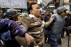 A In Kathmandu, Nepalese government security forces apprehend a protestor at a Democracy Day demonstration, February 18, 2005. (c) 2005 Bruno Stevens 