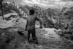 A child miner works in the grueling conditions of an open pit gold mine in Watsa, northeastern Congo. �2004 Marcus Bleasdale.
