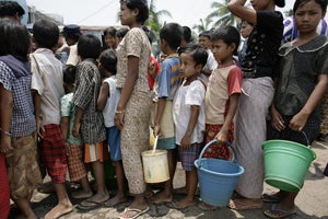 People stand in line to receive water in a village affected by Cyclone Nargis, Burma. 
� 2008 Reuters