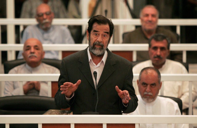 Saddam Hussein speaks to the judge as his trial begins in Baghdad. Human Rights Watch is calling for fair trials to ensure justice for hundreds of thousands of Iraqi victims and their families.