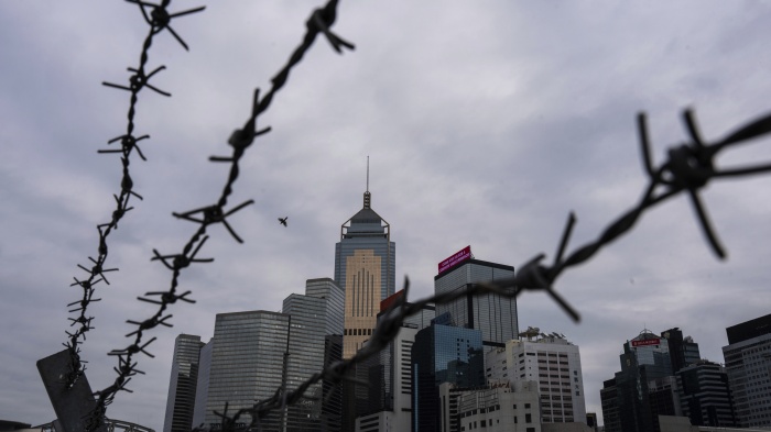 Hong Kong's cityscape through barbed wire.