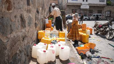 People fill jerrycans with water at a distribution point in Taizz, Yemen, October 20, 2026.