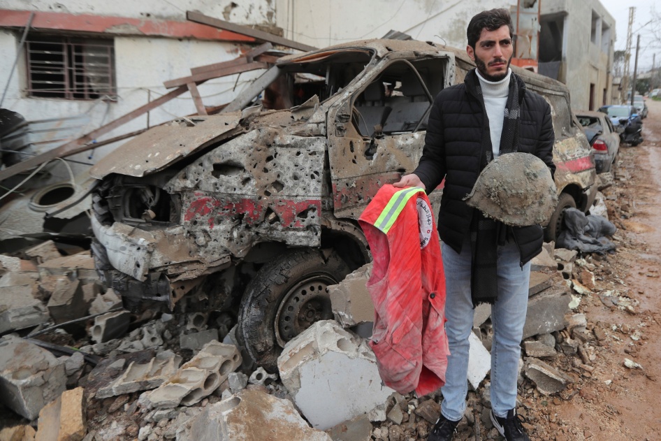 A man carries belongings of a paramedic killed at a paramedic center hit on March 27, 2024, by an Israeli airstrike in Habbarieh, southern Lebanon, March 27, 2024. 