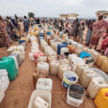 Sudanese women and children who fled the conflict in Geneina, in Sudan's Darfur region, line up at the water point in Adre, Chad, July 30, 2023. 