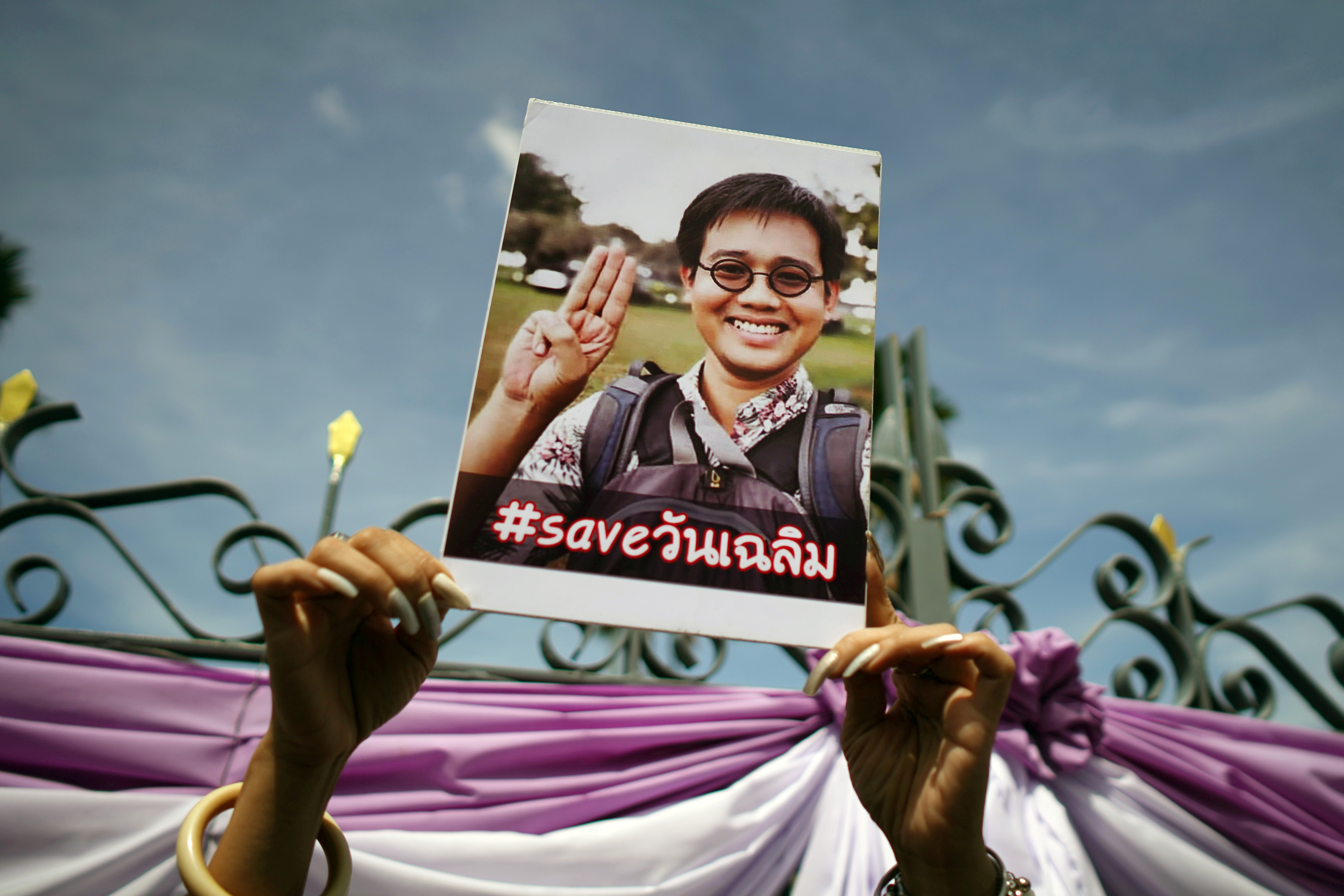 A photo of Thai activist Wanchalearm Satsaksit being held up as people gather in support of him during a protest calling for an investigation, in front of Government House in Bangkok, Thailand, June 12, 2020.