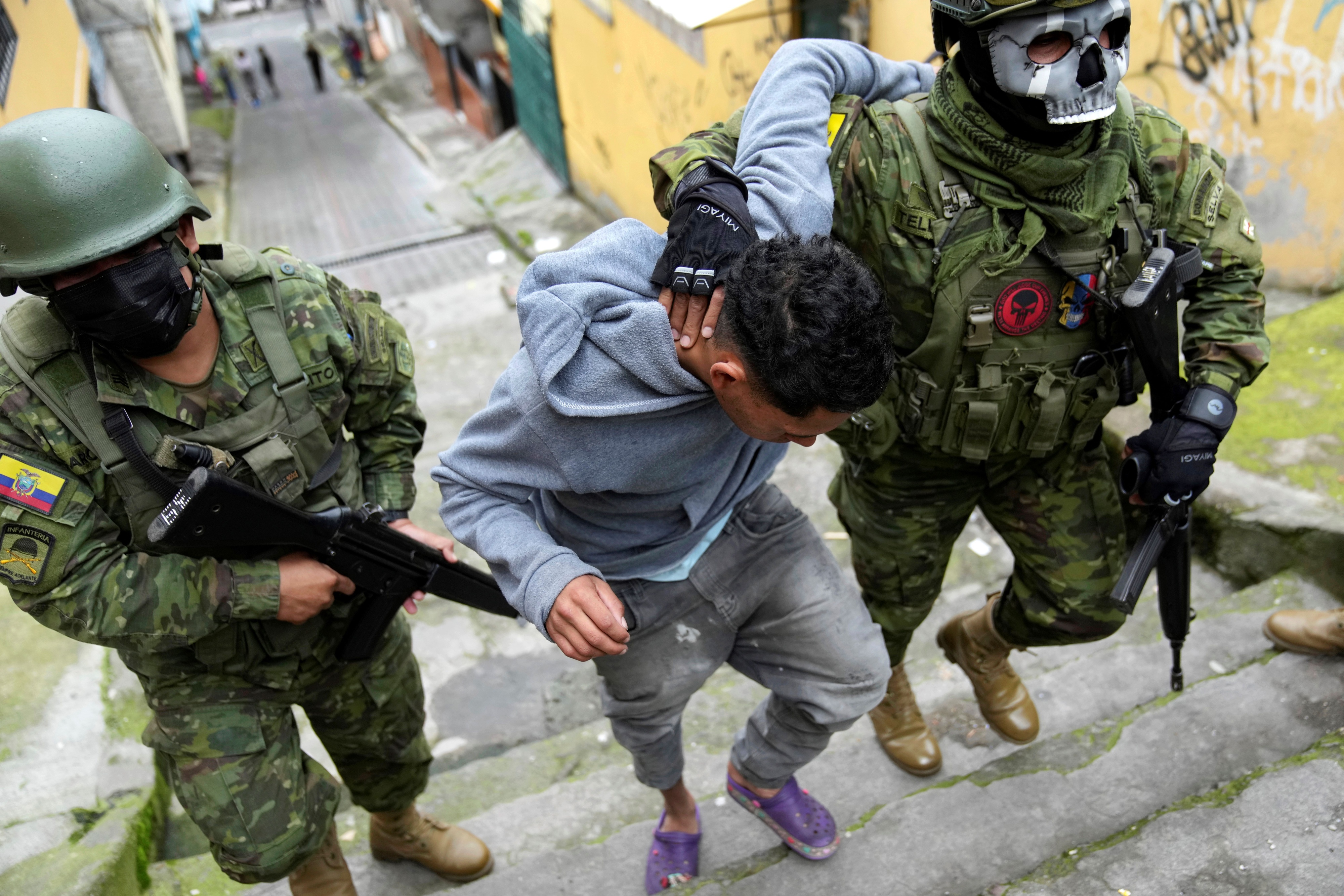 Soldiers briefly detain a youth to walk him to an area to check if he has gang-related tattoos as they patrol the south side of Quito, Ecuador, Friday January 12, 2024..