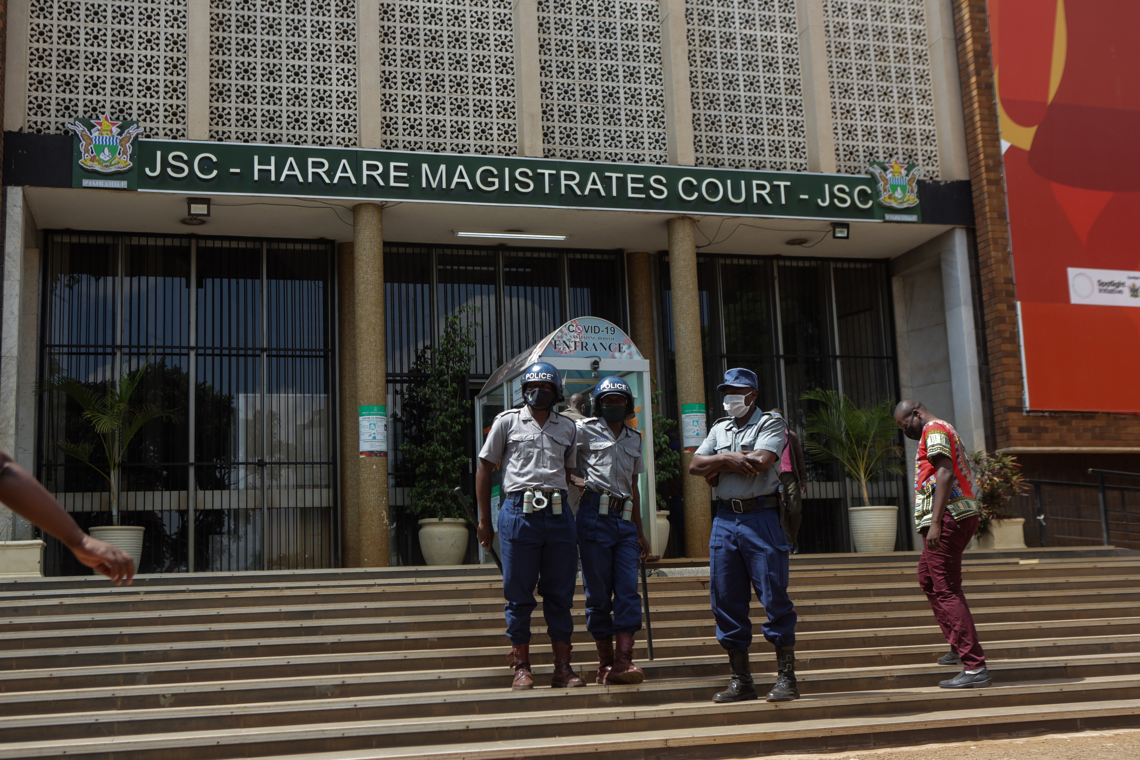 Police officers outside the Magistrates Court in Harare, Zimbabwe, April 6, 2021.