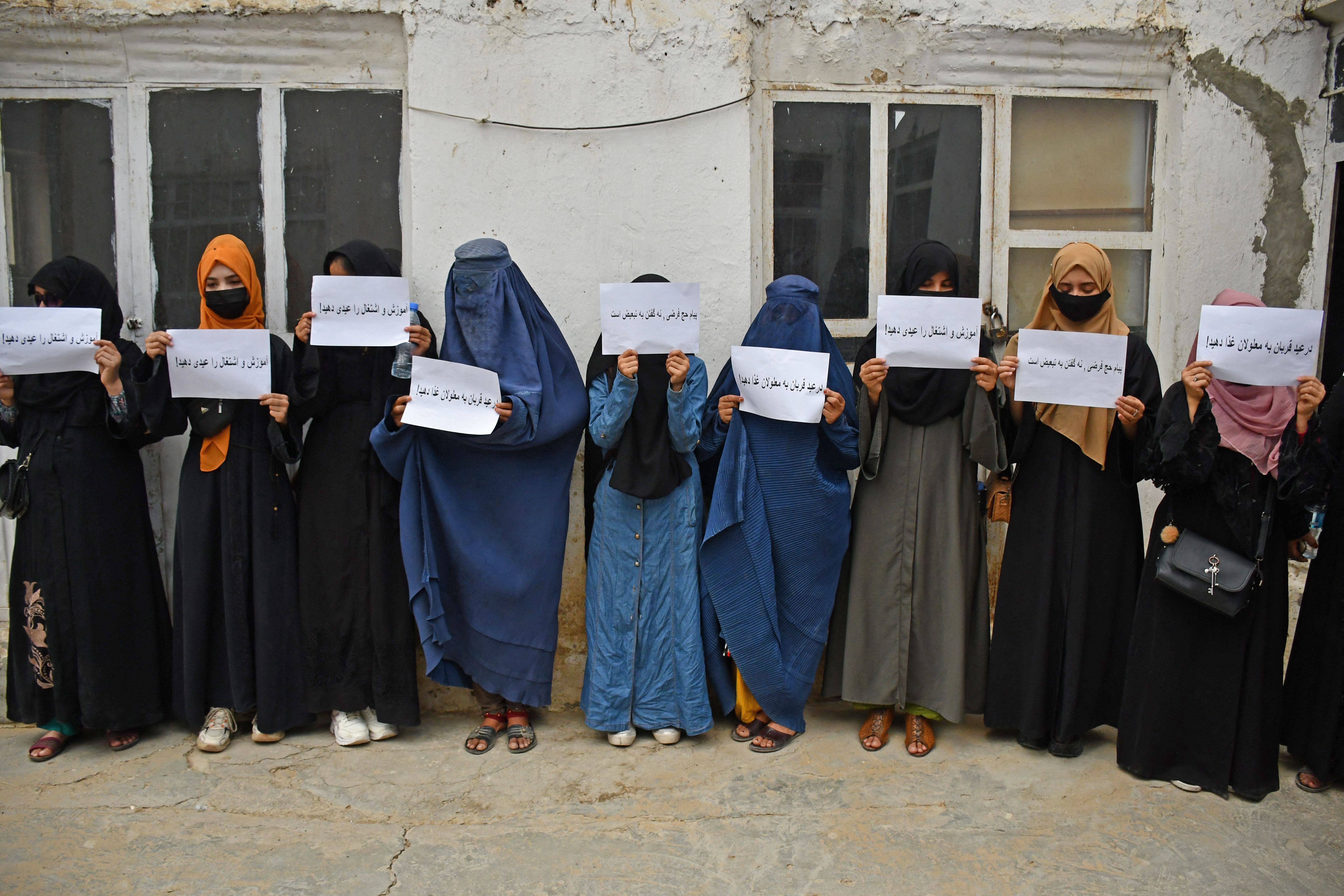 Afghan women hold placards demanding their right to education, in Mazar-i-Sharif on June 26, 2023. 