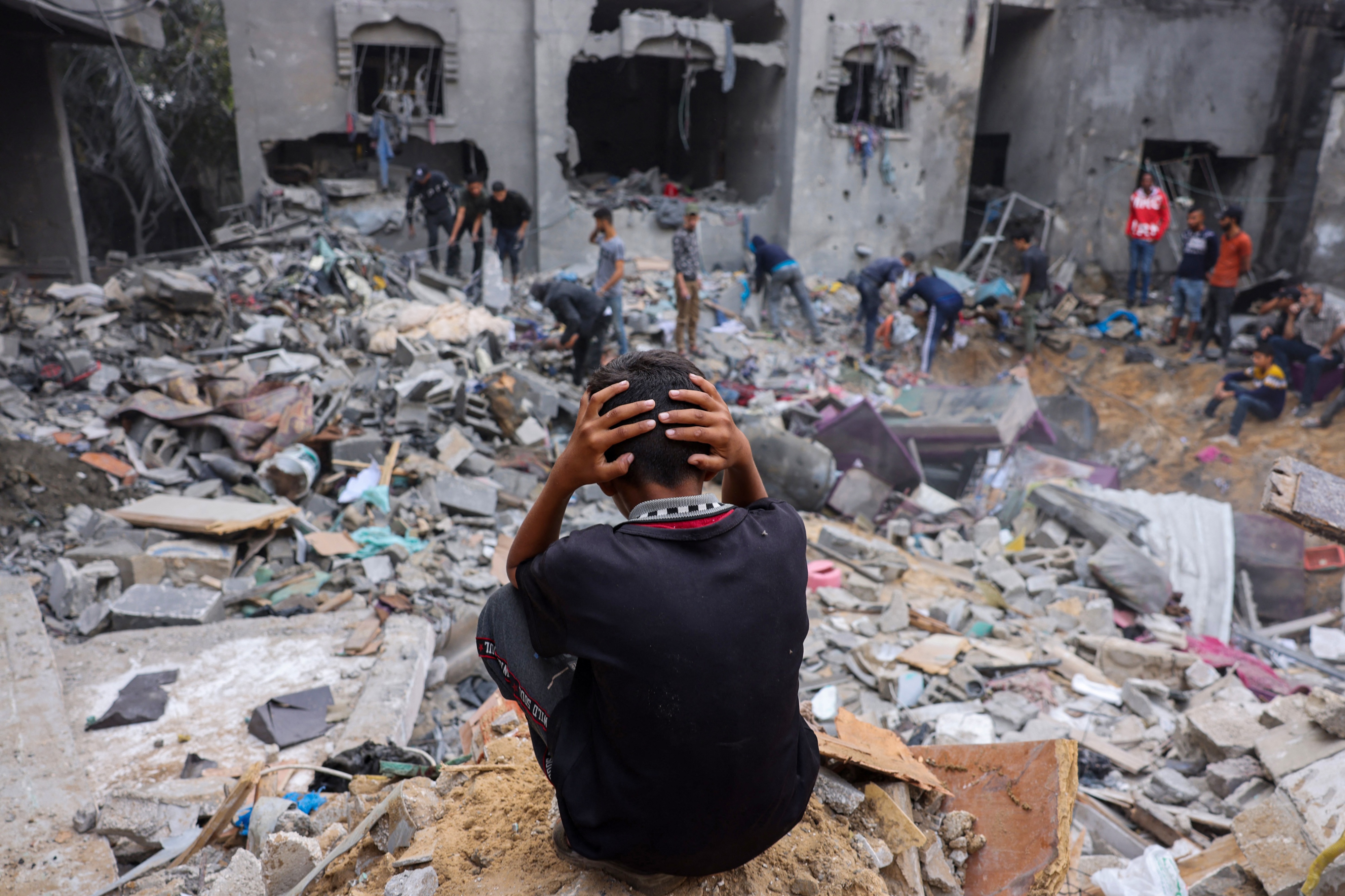eople salvage belongings amid the rubble of a damaged building following strikes on Rafah in the southern Gaza Strip, November 12, 2023. 