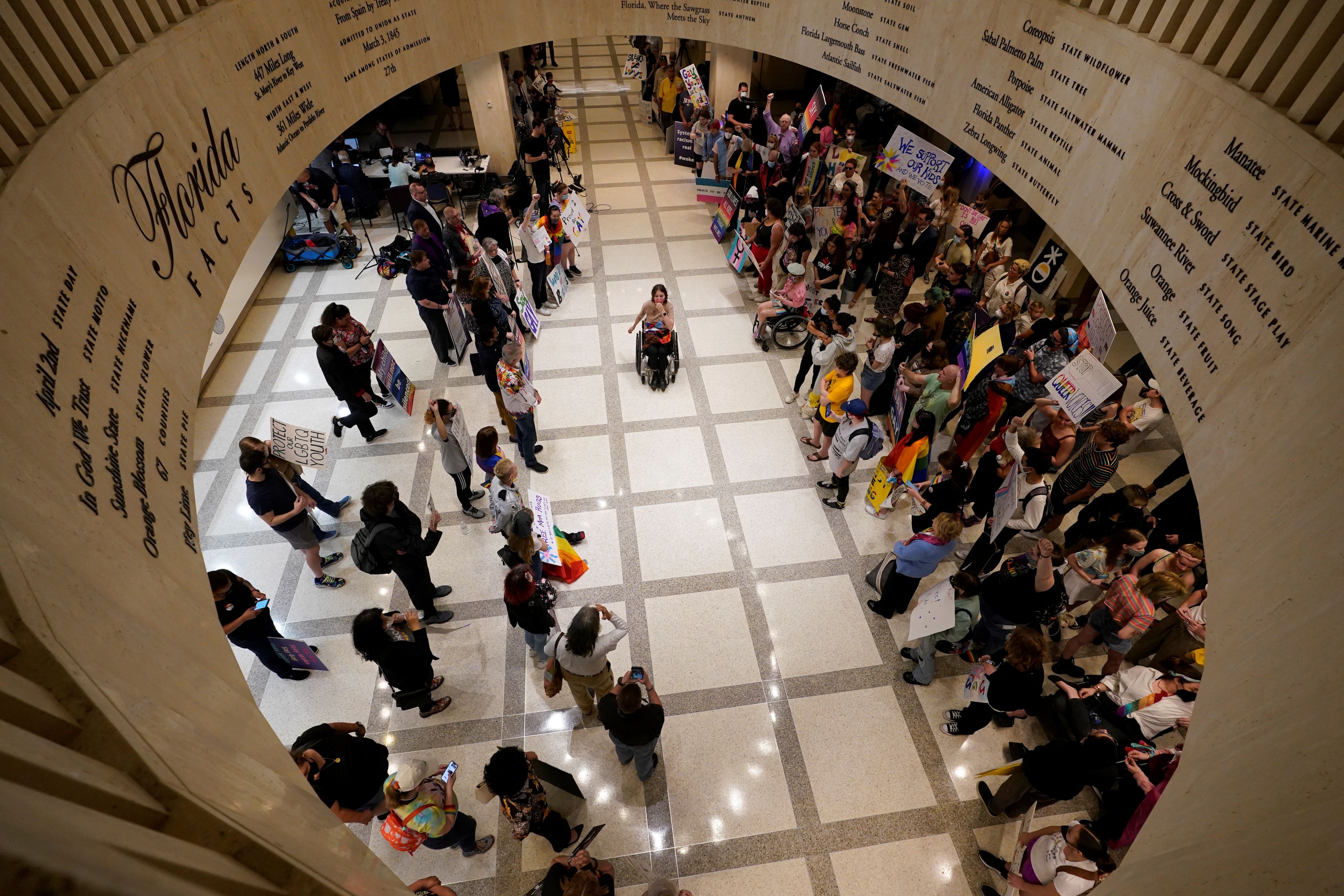 Overhead shot of people protesting in the lobby of the Florida state capitol