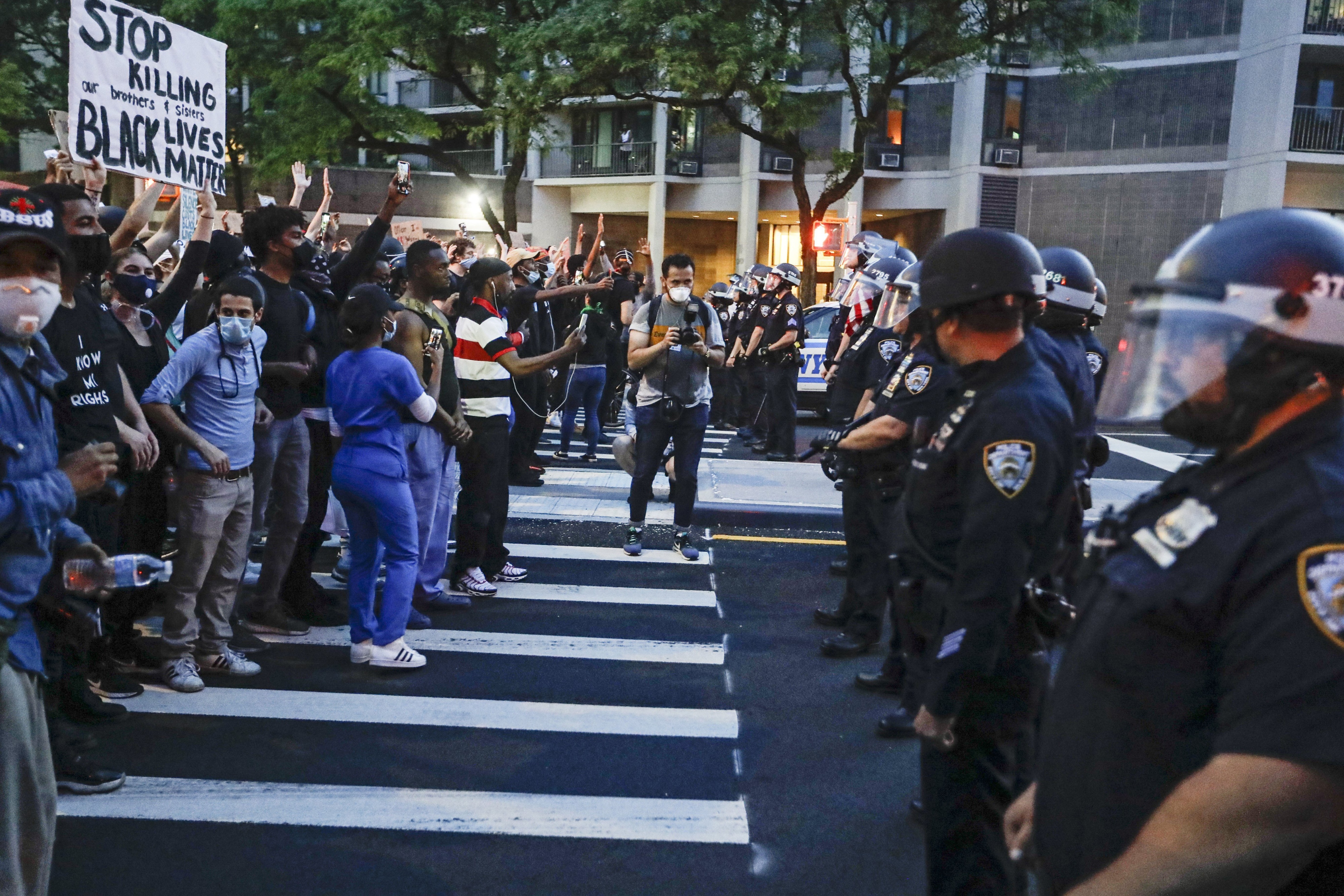 Protesters confront New York Police officers as part of a solidarity rally calling for justice over the death of George Floyd, in the Brooklyn, New York, June 3, 2020. 