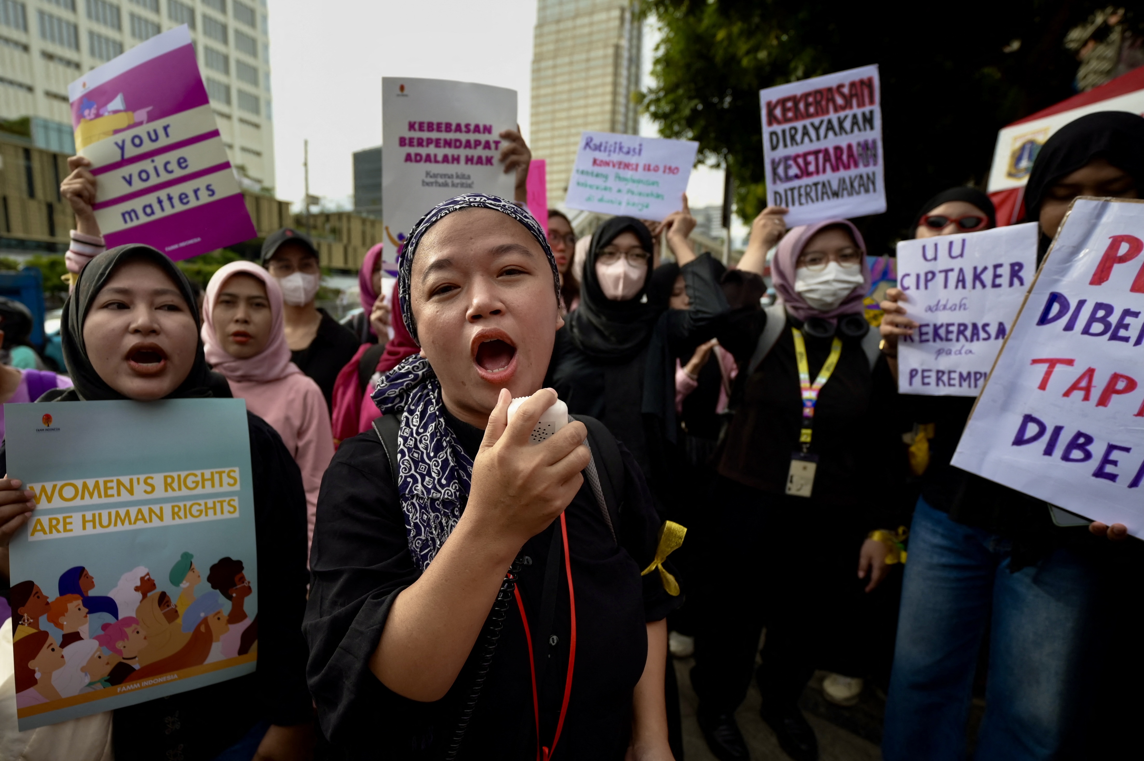 Indonesian women march to demand the Indonesian government enacts an anti-discrimination law and to advocate for ending sexual violence and harassment at work, March 8, 2024.