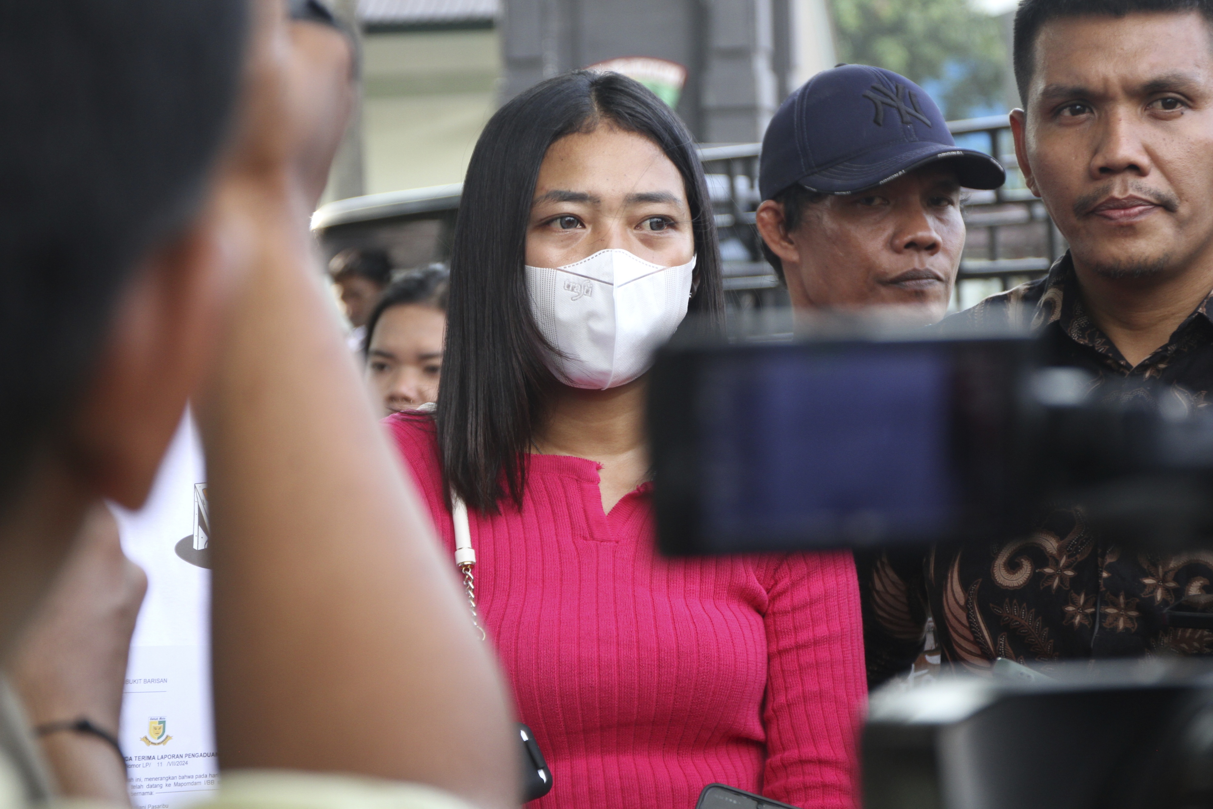 Eva Meliana Pasaribu, daughter of the late journalist Rico Sempurna Pasaribu, delivers a press statement