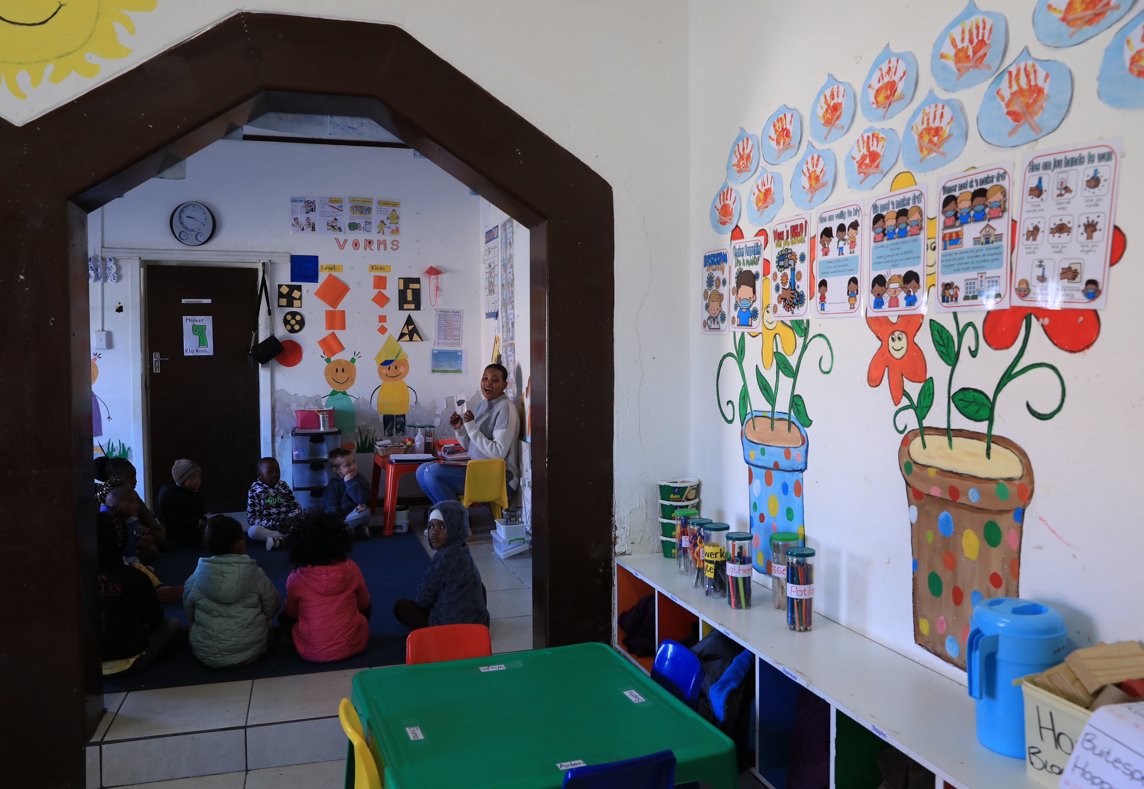 A teacher gives lessons to children at an early learning center in De Aar Town, South Africa, August 11, 2023.