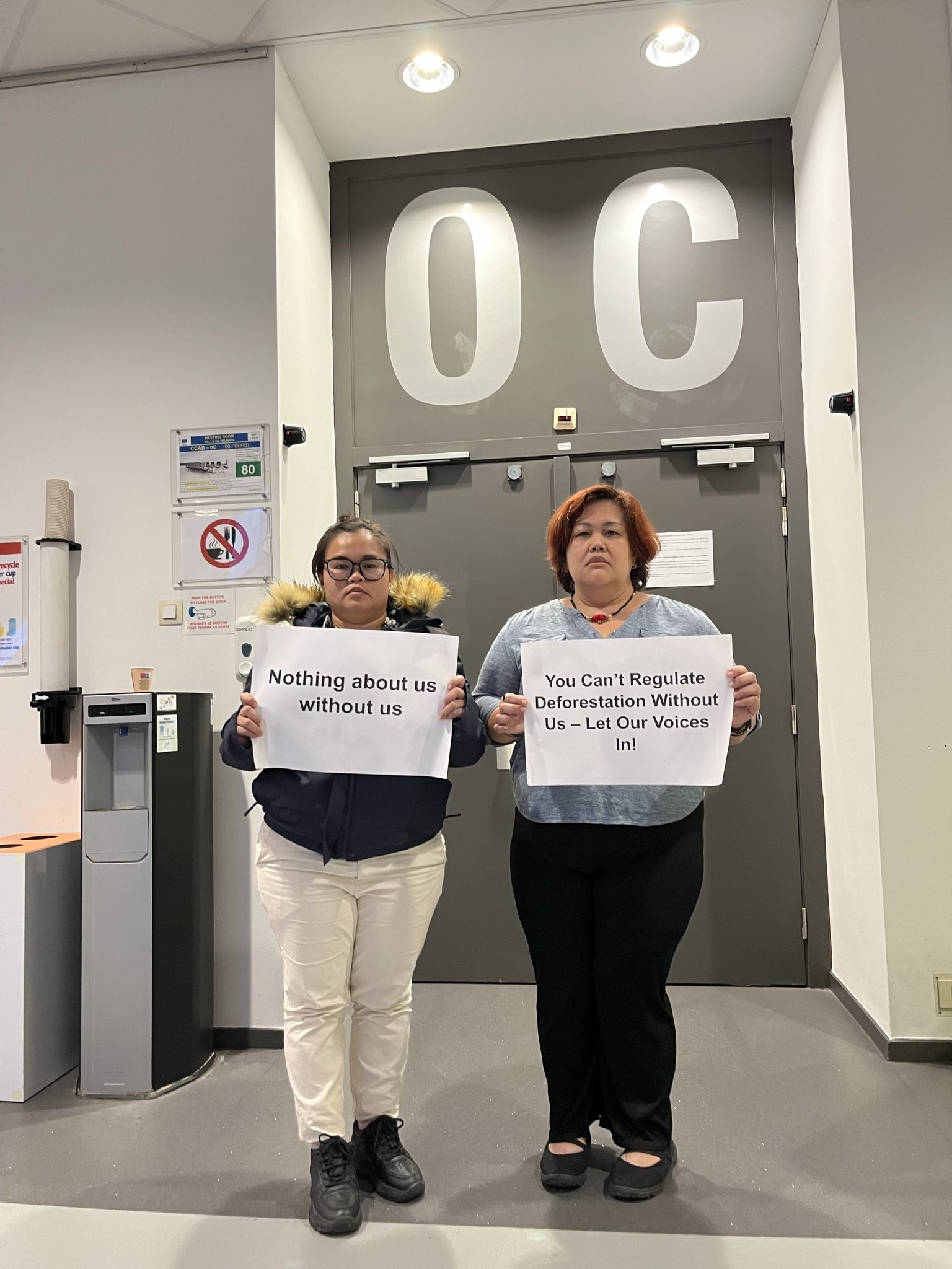 Dayang Ukau (L) and Celine Lim, leaders of the Indigenous organizations KERUAN and SAVE Rivers respectively, protest Malaysia's refusal to allow in-person civil society participation at the EU-Indonesia-Malaysia Joint Taskforce on the EU Deforestation Regulation outside the meeting room, Brussels, September 12, 2024.