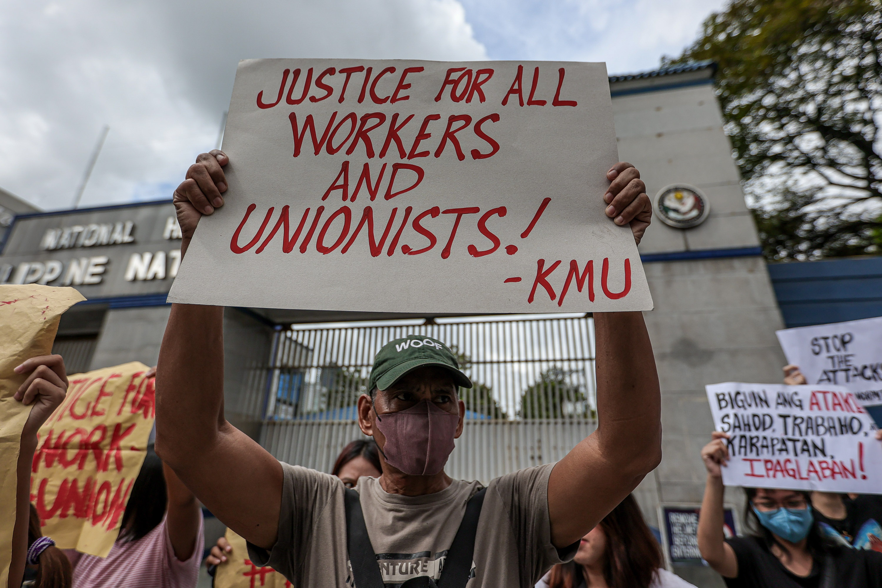 Workers hold a rally outside police headquarters in Quezon City, Philippines, in response to the brutal killing the previous week of  labor organizer Jude Thaddeus Fernandez from Kilusang Mayo Uno, October 5, 2023. 