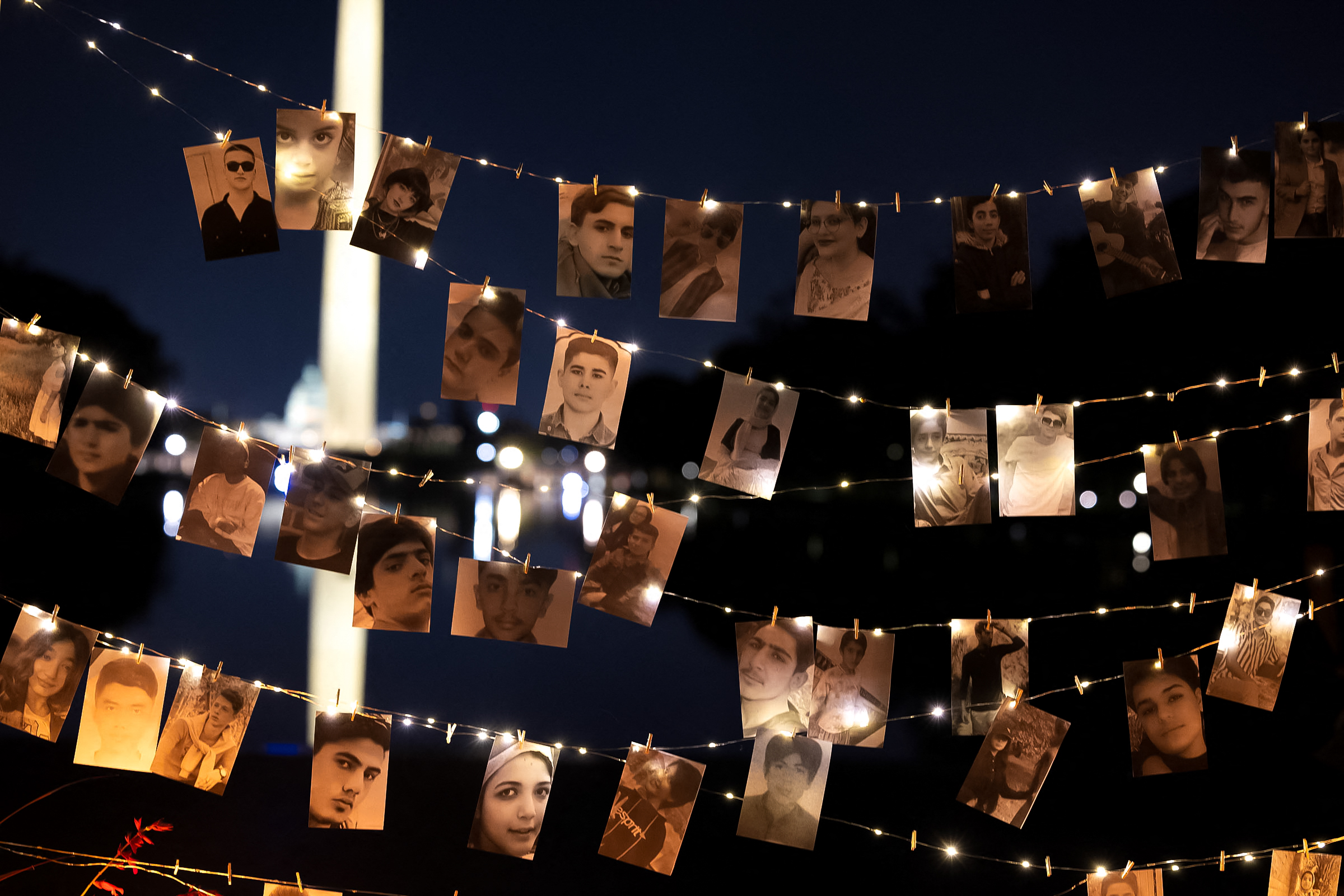 A display of photos that includes protesters executed by the Iranian government at a candlelight vigil honoring Mahsa Zhina Amini and the demonstrators, in Washington DC, September 16, 2023.