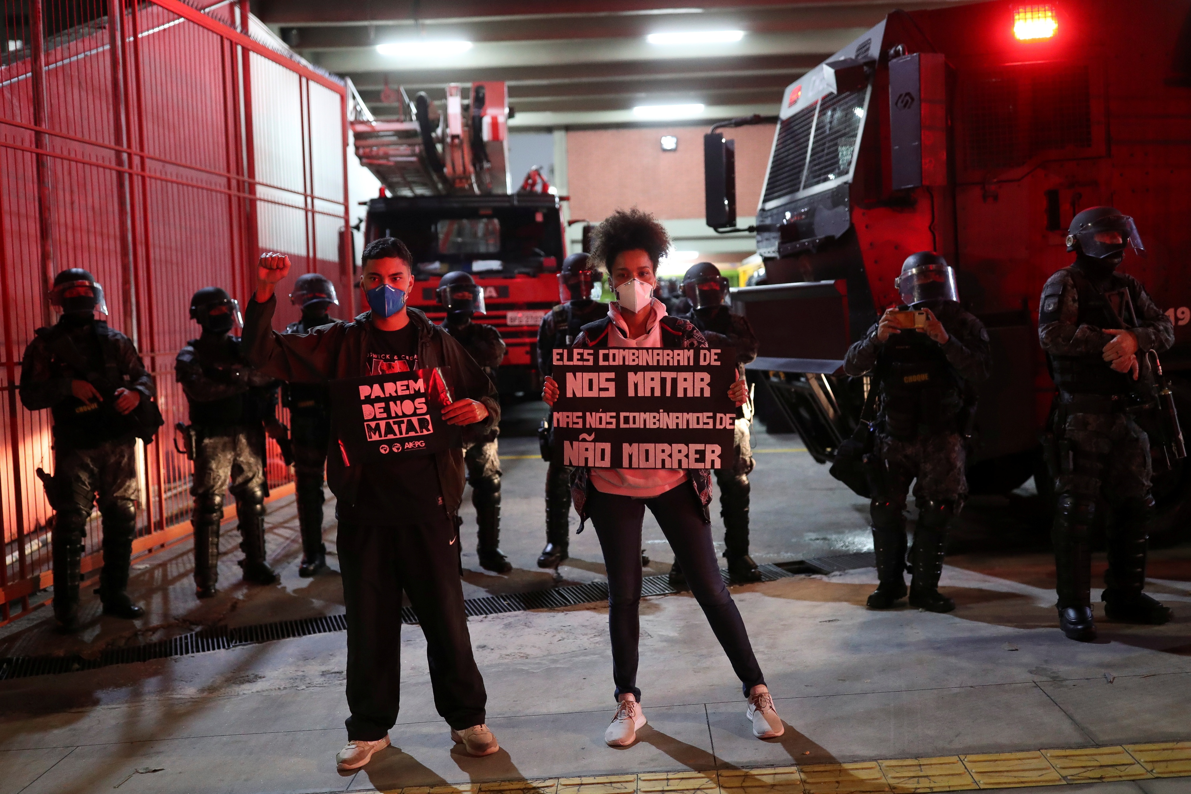 Activists protest in Sao Paulo against racism, police violence, and against a police operation that took place in Jacarezinho in Rio de Janeiro, Brazil, May 13, 2021. The placards read "Stop killing us" and "They agreed to kill us, and we agreed not to die".