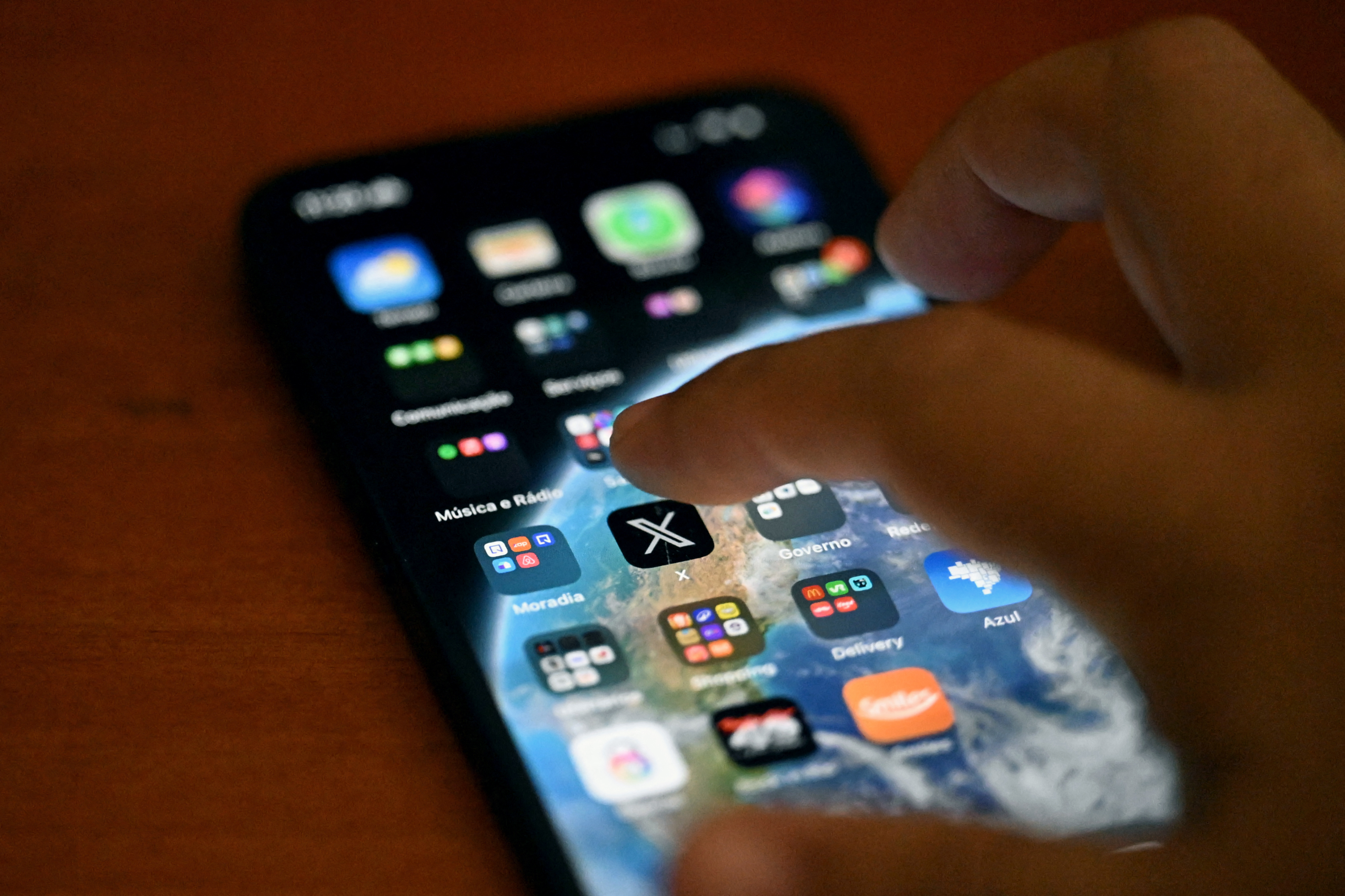 A person clicks on the X app on a smartphone, in Rio de Janeiro, Brazil, on September 18, 2024. 