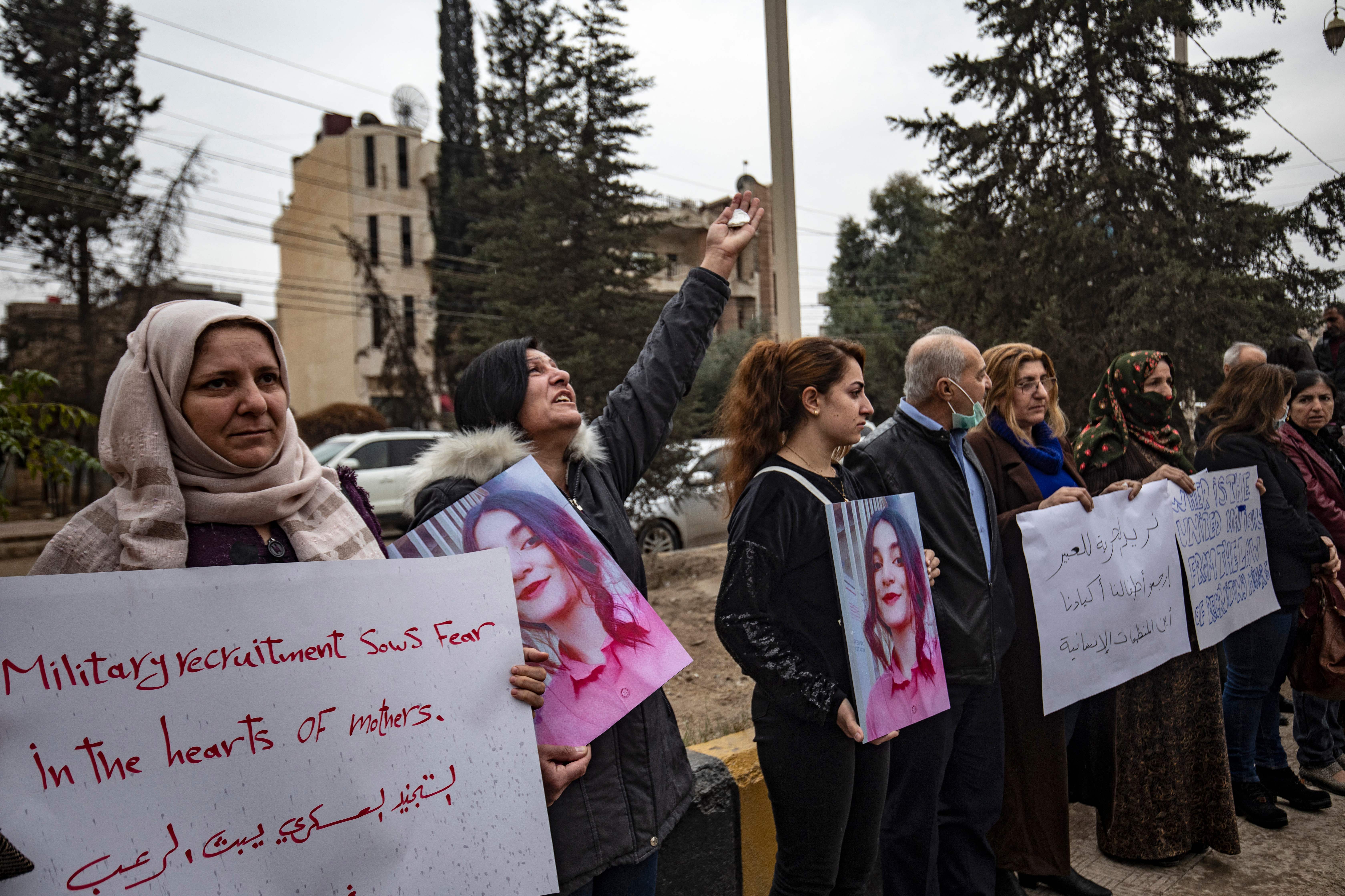 Syrian Kurds demonstrate outside a UN building, calling on WHICH??authorities to help obtain the release of girls abducted and recruited into fighting, in the northeast city of Qamishli, November 28, 2021.