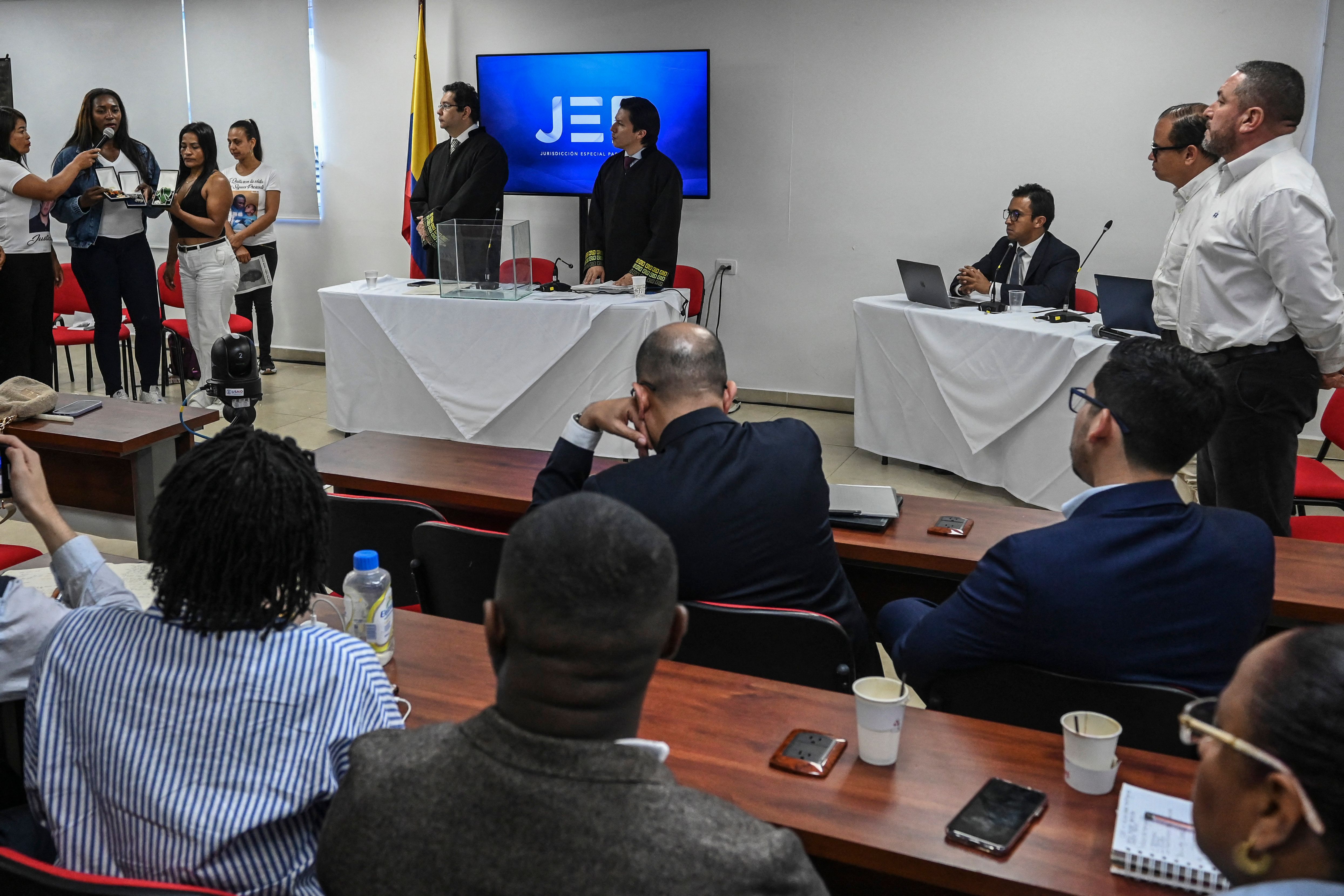 Relatives of victims of extrajudicial executions and magistrates are pictured during a hearing of the Special Jurisdiction for Peace (JEP) in Cali, Colombia on June 5, 2023.