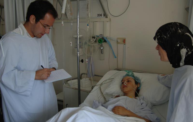 Nadim Houry (left) interviews a civilian casualty in Lebanon. 