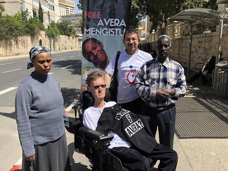 Avera Mangistu's parents and disability rights activists at a protest tent in Jerusalem.