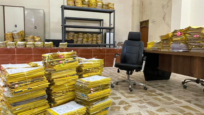 Piles of applications in the Tel Afar compensation office. 