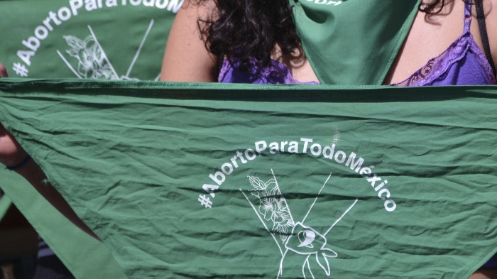 Green handkerchiefs displayed at a rally