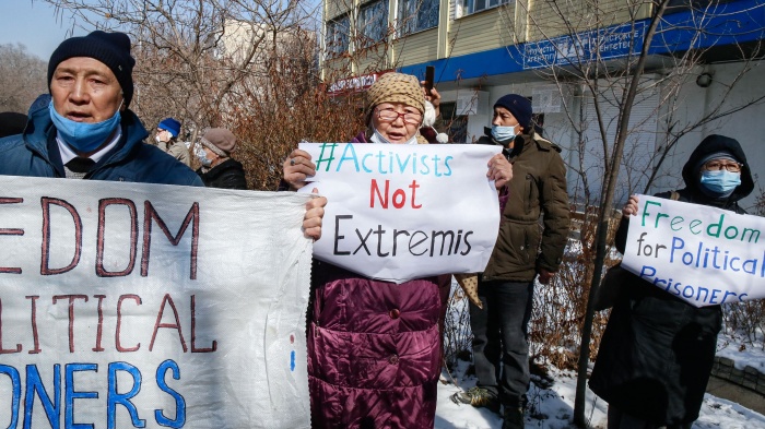 Protesters hold placards during an opposition rally