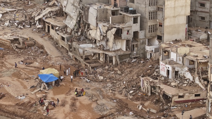 Rescuers and relatives of victims set up tents in front of collapsed buildings in Derna, Libya, September 18, 2023.