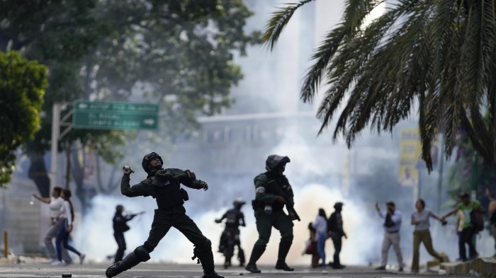 Police hurl a tear gas canister at protesters demonstrating against the announced election results declaring Nicolas Maduro's reelection, the day after the vote, in Caracas, Venezuela, July 29, 2024.