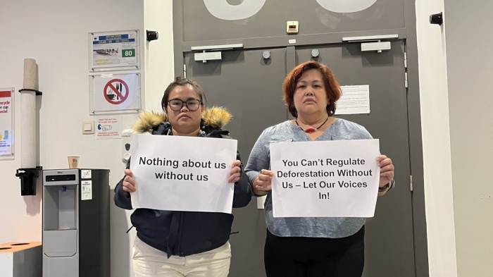 Dayang Ukau (L) and Celine Lim, leaders of the Indigenous organizations KERUAN and SAVE Rivers respectively, protest Malaysia's refusal to allow in-person civil society participation at the EU-Indonesia-Malaysia Joint Taskforce on the EU Deforestation Regulation outside the meeting room, Brussels, September 12, 2024.