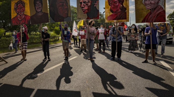 Climate activists hold up portraits of slain Philippine environmental defenders during the Global Day of Action for Climate Justice protest in Quezon City, Philippines, November 6, 2021.