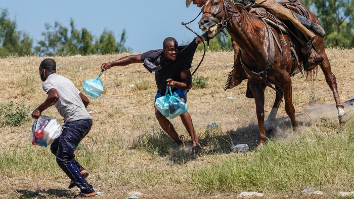 United States Border Patrol agent on horseback tries to stop Haitian migrants from entering an encampment on the banks of the Rio Grande near the Acuña Del Rio International Bridge in Del Rio, Texas on September 19, 2021.