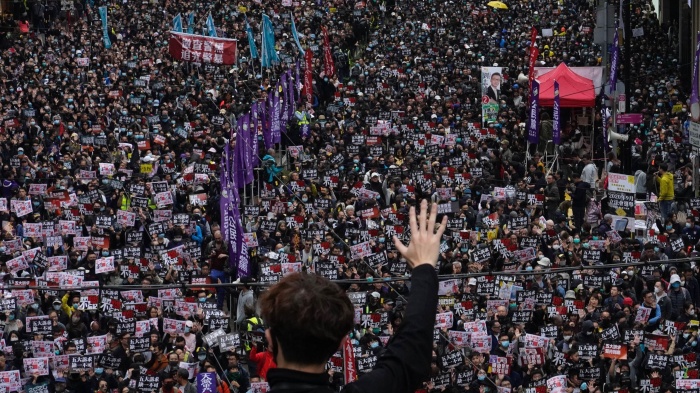 A protestor shows five demands gesture as Hong Kong people participate in their annual pro-democracy march in Hong Kong, January 1, 2020. 