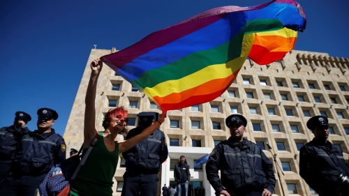 A protester holding an LGBT flag