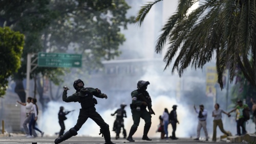 Police hurl a tear gas canister at protesters demonstrating against the announced election results declaring Nicolas Maduro's reelection, the day after the vote, in Caracas, Venezuela, July 29, 2024.