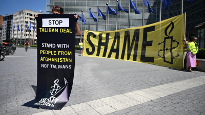 An activist at EU Commission headquarters protests against a meeting with a Taliban delegation in Brussels, Belgium, June 23, 2026.