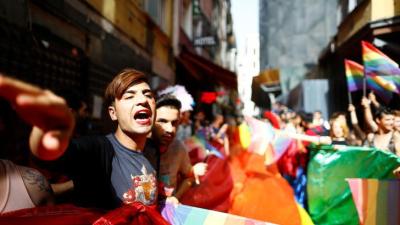 LGBT rights activists hold a rainbow flag during a transgender pride parade which was banned by the governor’s office, in central Istanbul, Turkey, June 19, 2016