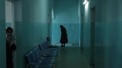 An employee cleans the corridor of the women's ward at the mental health hospital in Kabul, November 2012.