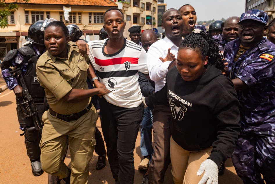 Members of the Uganda Police force arrest protesters marching to parliament during a planned anti-corruption demonstration in Kampala on July 23, 2024. 