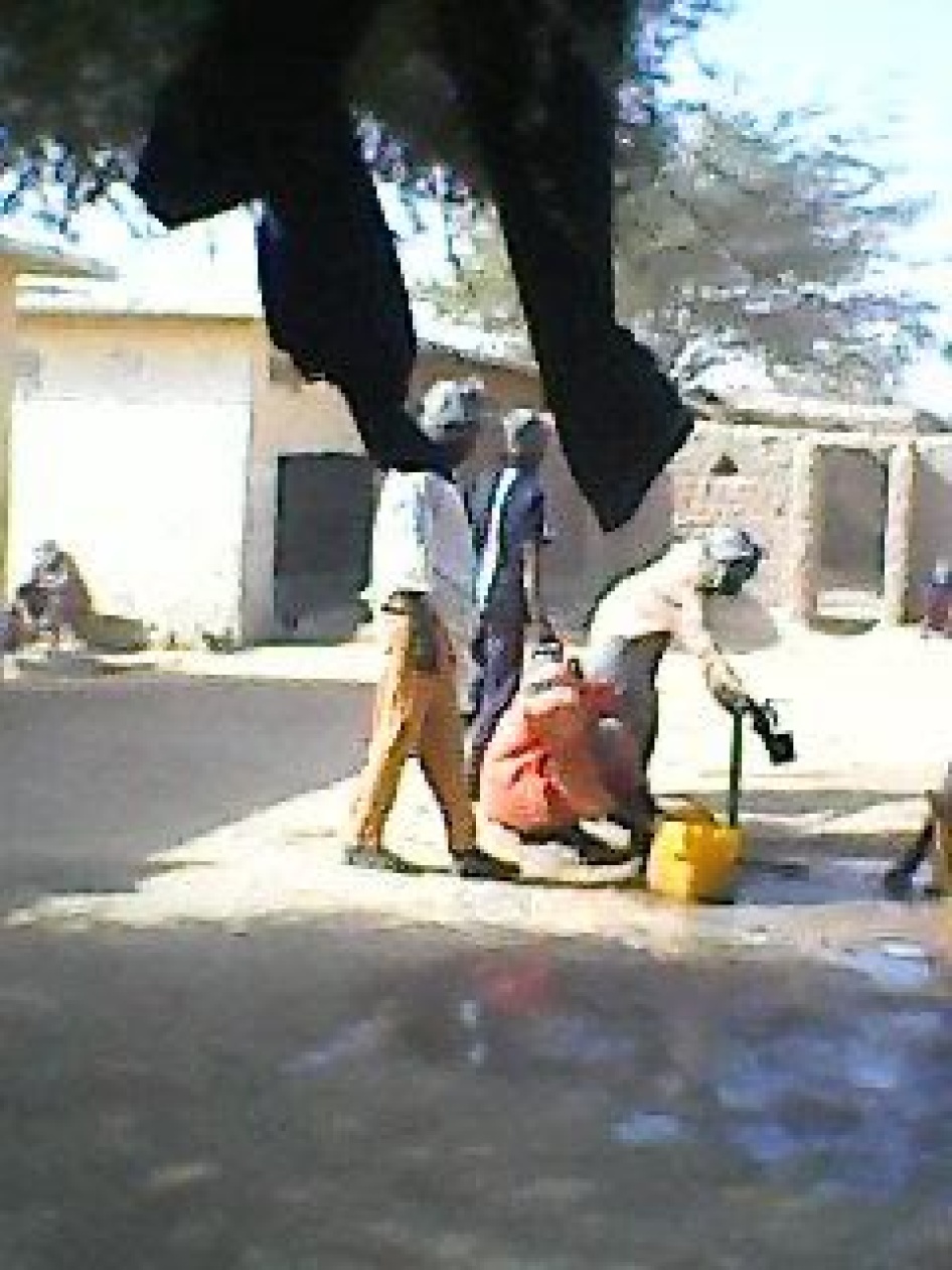 Men using an outdoor water pump