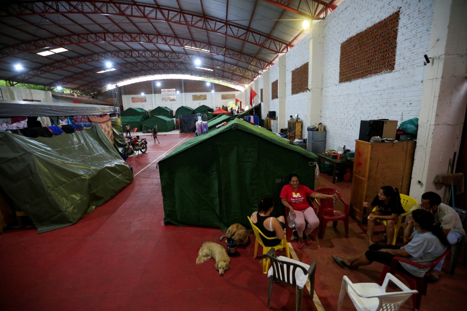 Displaced residents chat on a school court used as a temporary shelter after the Parana river overflowed its banks due to heavy rain upstream, in Ayolas, Paraguay November 8, 2023.