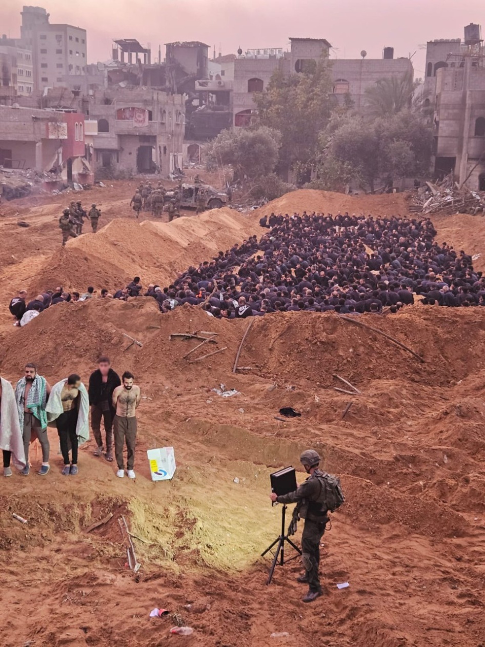 Dr. Khalid Hamoudeh (far left in the front) and Dr. Wadee Qasem (far right in the front) are detained along with other healthcare workers, internally displaced civilians, and patient’s families near the Kamal Adwan Hospital in northern Gaza.