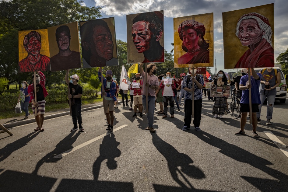 Climate activists hold up portraits of slain Philippine environmental defenders during the Global Day of Action for Climate Justice protest in Quezon City, Philippines, November 6, 2021.