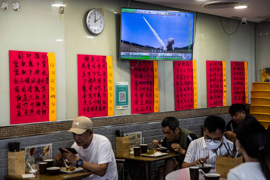 A television in a restaurant in Hong Kong shows a missile being launched during military exercises being held by China around the island of Taiwan, June 3, 2026.