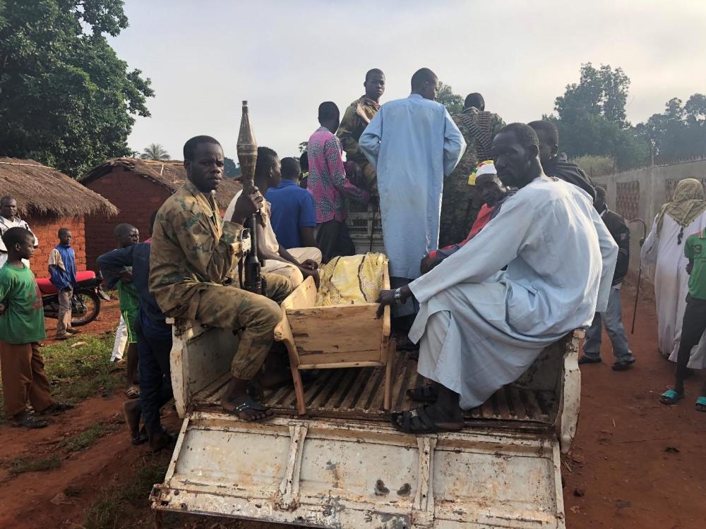 Civilians and Seleka fighters from the Popular Front for the Renaissance in the Central African Republic (Front Populaire pour la Renaissance de la Centrafrique, FPRC) move the body of Mariam Hussein for burial on September 22, 2018. Hussein was killed t